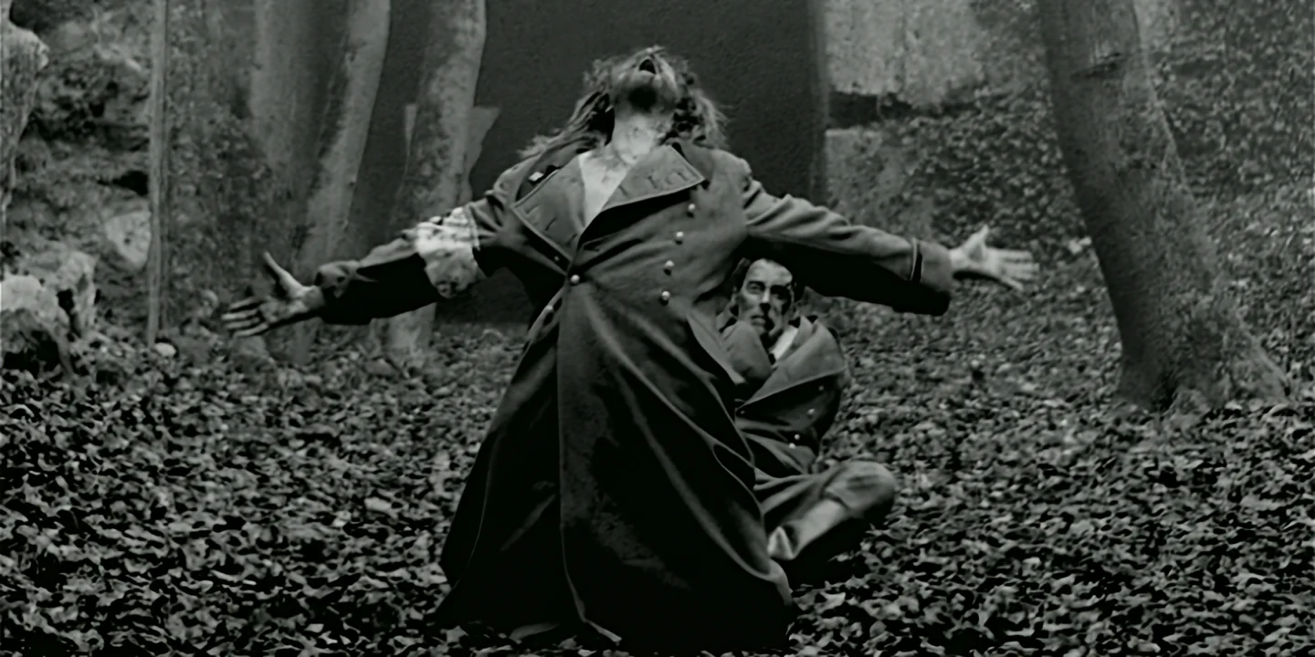 Man in military coat with arms outstretched in forest, black and white Clone short film