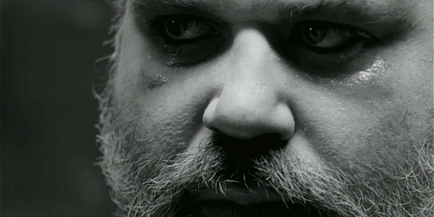 Very close-up of white-bearded scientist with wet face, sad and angry after crying, Clone short film