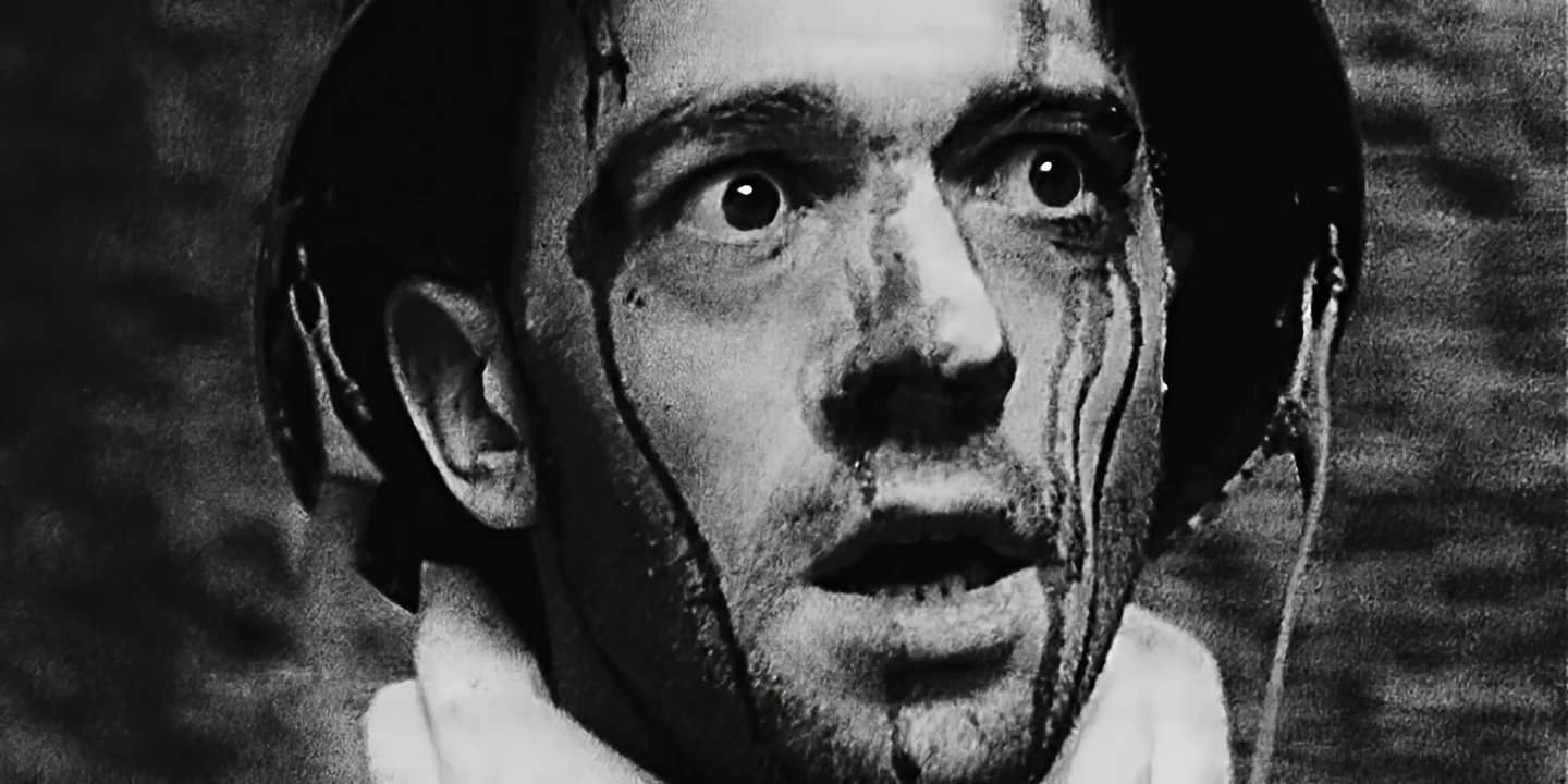 Close-up of helmeted soldier in distress, black and white, zombie style, GAS short film