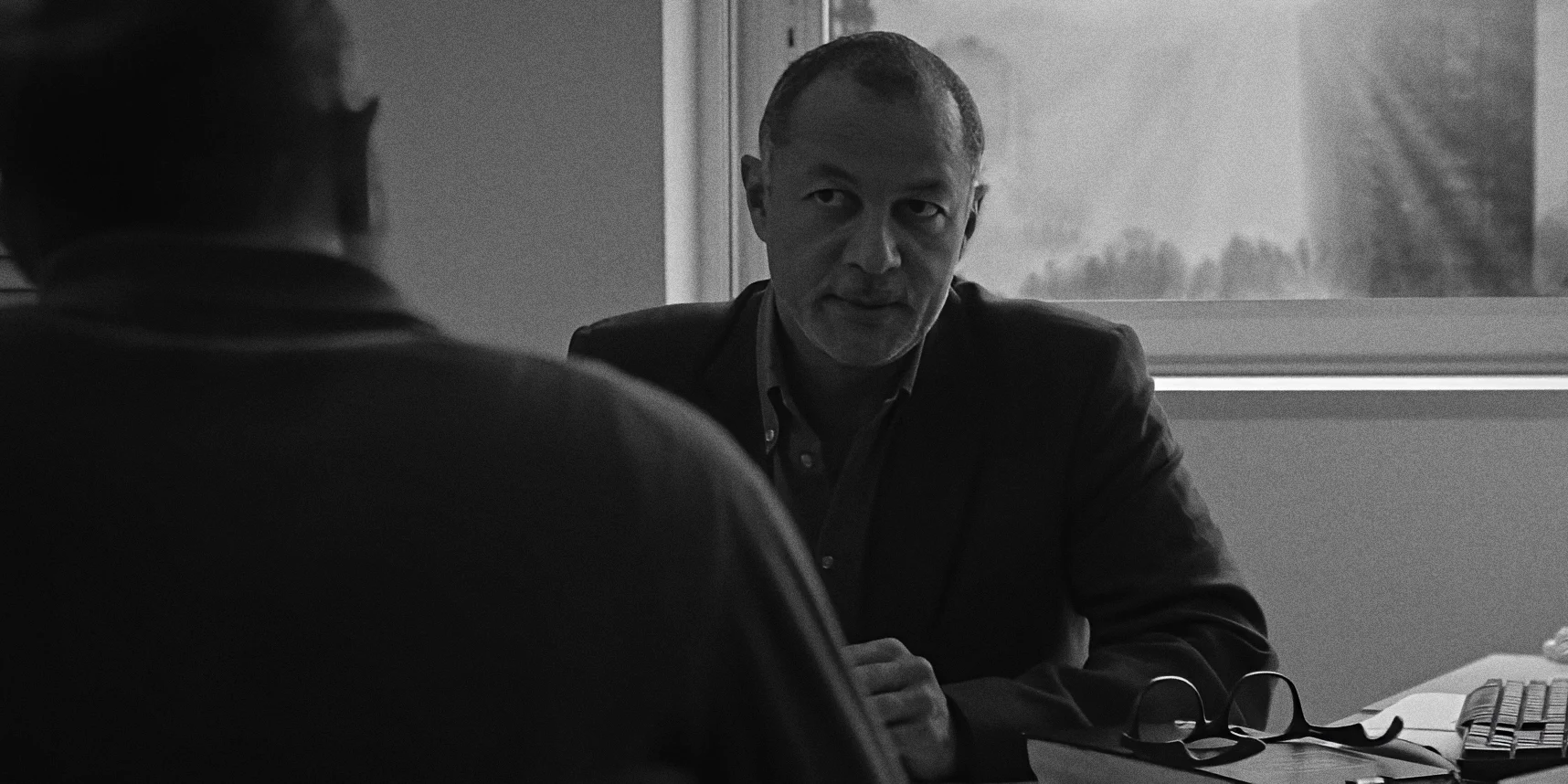 Boss firing employee in office with city backdrop, harsh moment, Twice as Far